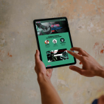 Free mockup of man pointing on iPad (Mockuuups Studio)